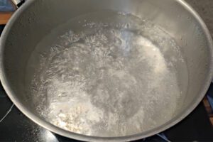 Fresh tagliatelle being boiled in salted water