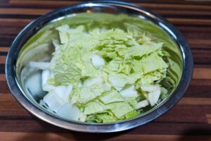 Cutting napa cabbage (Baechu / 배추) into bite-sized pieces.