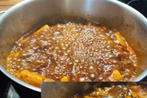 Soaked wheat Tteok being added to the pot for Tteokbokki