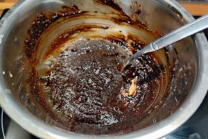 Stirring the ingredients into a smooth, creamy red sauce for Tteokbokki.